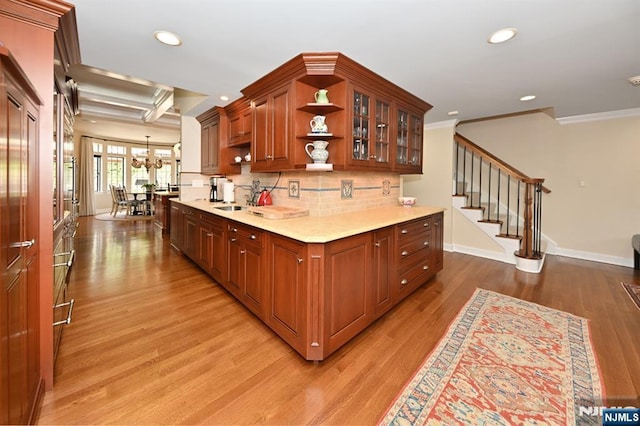kitchen featuring open shelves, recessed lighting, light countertops, light wood finished floors, and backsplash