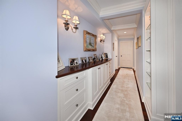 corridor featuring crown molding, baseboards, beam ceiling, and built in shelves