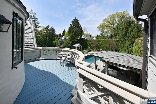 deck featuring a fenced in pool