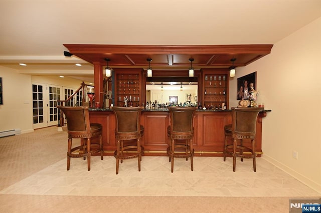 bar with baseboards, pendant lighting, a dry bar, and french doors