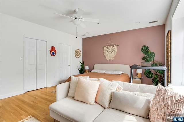 99 Park Ave Unit 5D, Hoboken, NJ 07030 - bedroom featuring ceiling fan, visible vents, wood finished floors, baseboards, and two closets