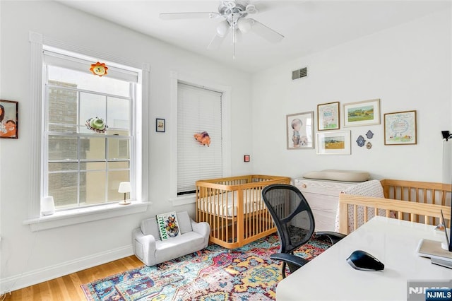 99 Park Ave Unit 5D, Hoboken, NJ 07030 - bedroom with baseboards, ceiling fan, wood finished floors, and visible vents