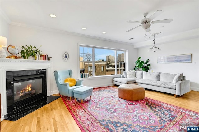 99 Park Ave Unit 5D, Hoboken, NJ 07030 - living area with a ceiling fan, wood finished floors, a glass covered fireplace, ornamental molding, and recessed lighting