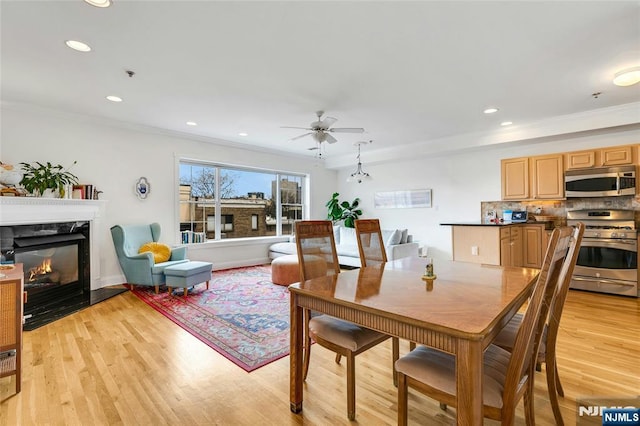 99 Park Ave Unit 5D, Hoboken, NJ 07030 - dining area with crown molding, a ceiling fan, light wood finished floors, and a fireplace