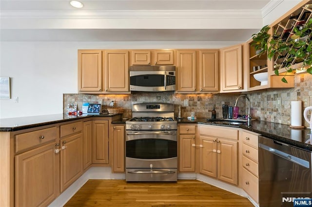 99 Park Ave Unit 5D, Hoboken, NJ 07030 - kitchen with crown molding, a sink, stainless steel appliances, a peninsula, and tasteful backsplash