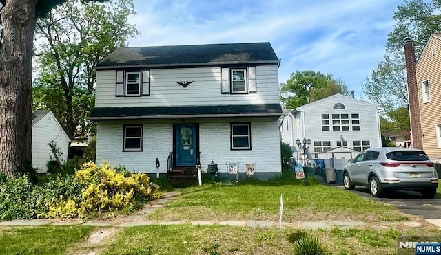 traditional home featuring a front yard and entry steps