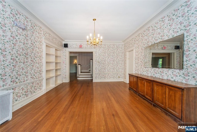 unfurnished dining area with wallpapered walls and wood finished floors