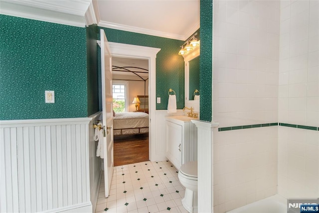full bathroom with toilet, ensuite bathroom, a wainscoted wall, vanity, and ornamental molding
