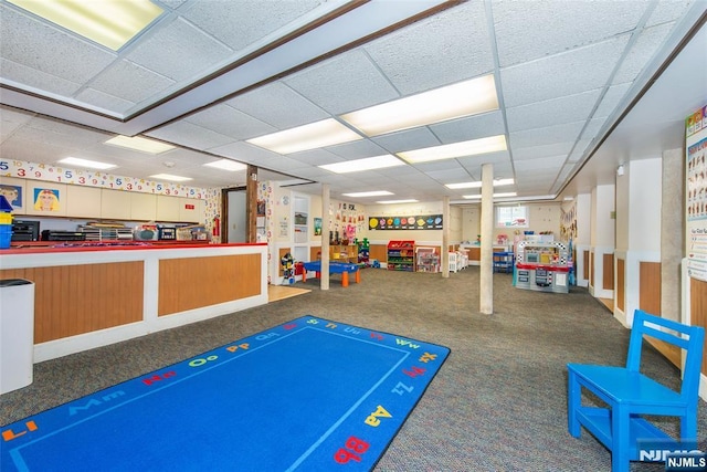 playroom featuring a drop ceiling and carpet