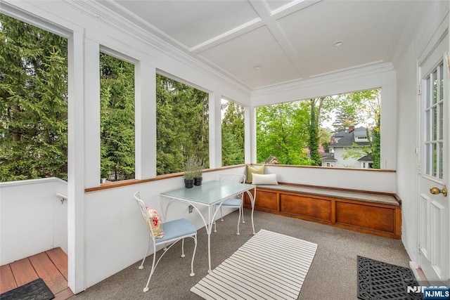 sunroom / solarium featuring coffered ceiling and ornamental molding
