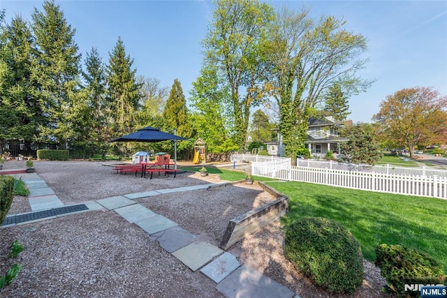 view of yard featuring a playground and fence