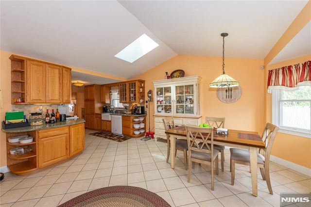 kitchen with open shelves, lofted ceiling with skylight, dishwasher, and dark countertops