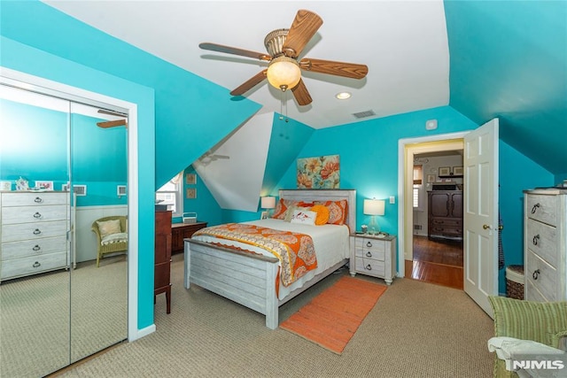 bedroom with visible vents, carpet flooring, a ceiling fan, and vaulted ceiling
