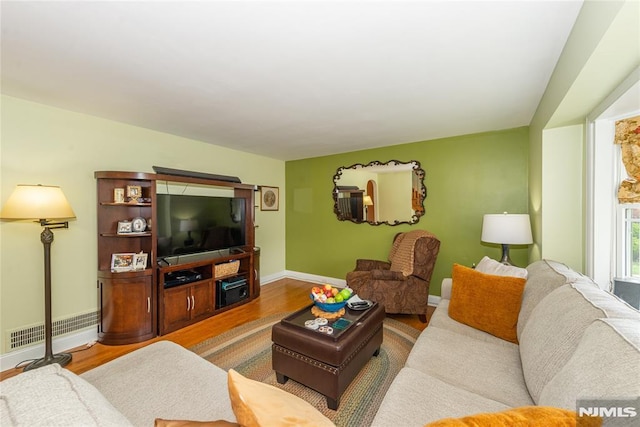 living room featuring baseboards, visible vents, and wood finished floors
