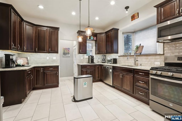 785 Ridgewood Rd, Twp Of Washington, NJ 07676 - kitchen featuring stainless steel appliances, a sink, backsplash, dark brown cabinets, and hanging light fixtures