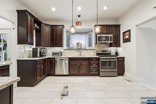 785 Ridgewood Rd, Twp Of Washington, NJ 07676 - kitchen with appliances with stainless steel finishes, a sink, tasteful backsplash, dark brown cabinetry, and recessed lighting
