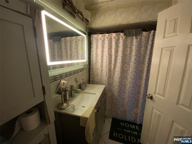 6314 Broadway, West New York, NJ 07093 - full bath featuring vanity, tile patterned floors, and a shower with shower curtain