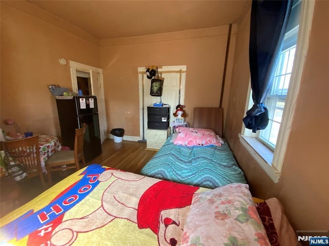 6314 Broadway, West New York, NJ 07093 - bedroom featuring freestanding refrigerator and wood finished floors