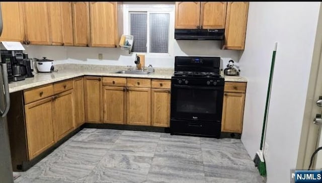 1215 Bergenline Ave, Union City, NJ 07087 - kitchen with black gas range oven, under cabinet range hood, light countertops, and a sink