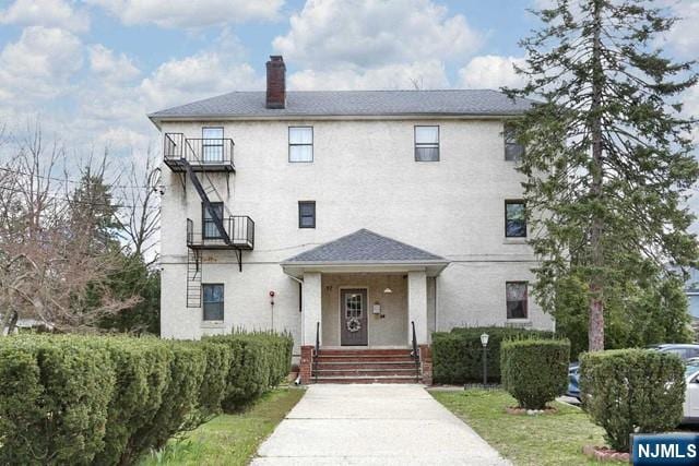 57 Brookway Ave Unit 2C, Englewood, NJ 07631 - view of front of house featuring a chimney and stucco siding