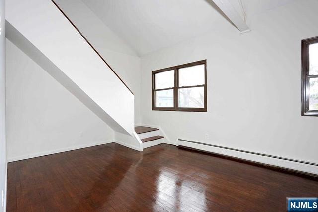 57 Brookway Ave Unit 2C, Englewood, NJ 07631 - additional living space featuring baseboards, a baseboard heating unit, wood finished floors, and lofted ceiling