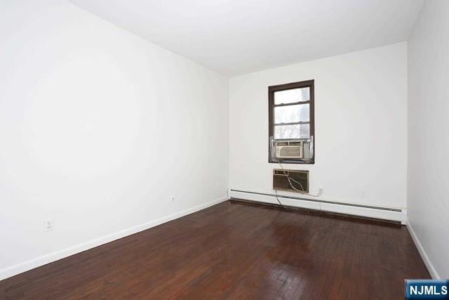 57 Brookway Ave Unit 2C, Englewood, NJ 07631 - empty room featuring baseboard heating, a wall mounted AC, wood finished floors, baseboards, and cooling unit