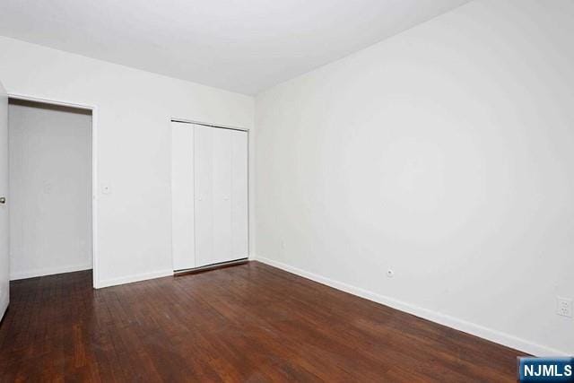 57 Brookway Ave Unit 2C, Englewood, NJ 07631 - unfurnished bedroom featuring baseboards, wood finished floors, and a closet
