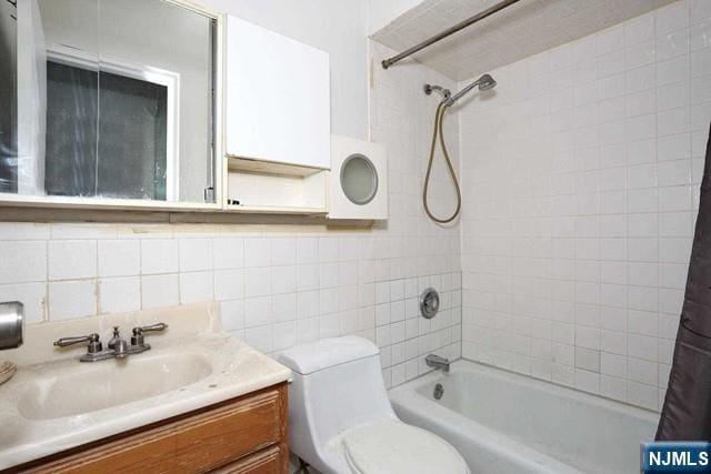 57 Brookway Ave Unit 2C, Englewood, NJ 07631 - bathroom featuring tile walls, tasteful backsplash, shower / bath combo, vanity, and toilet