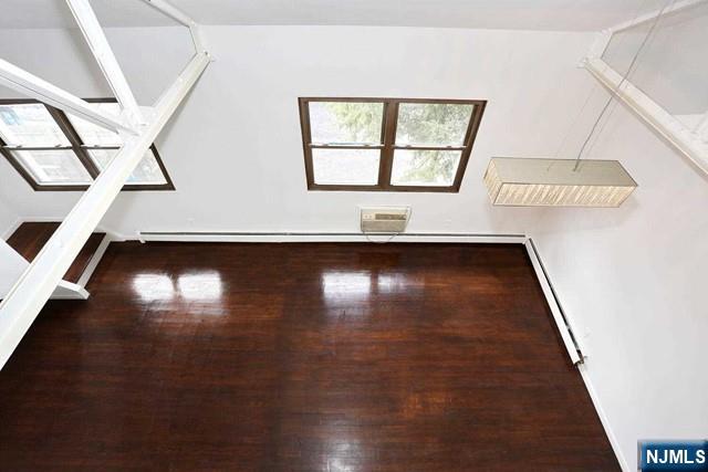 57 Brookway Ave Unit 2C, Englewood, NJ 07631 - additional living space featuring a baseboard heating unit and wood finished floors