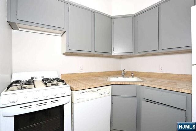 57 Brookway Ave Unit 2C, Englewood, NJ 07631 - kitchen with white appliances, a sink, gray cabinets, and light countertops