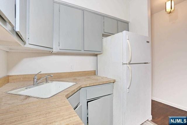 57 Brookway Ave Unit 2C, Englewood, NJ 07631 - kitchen with freestanding refrigerator, gray cabinets, a sink, and light countertops