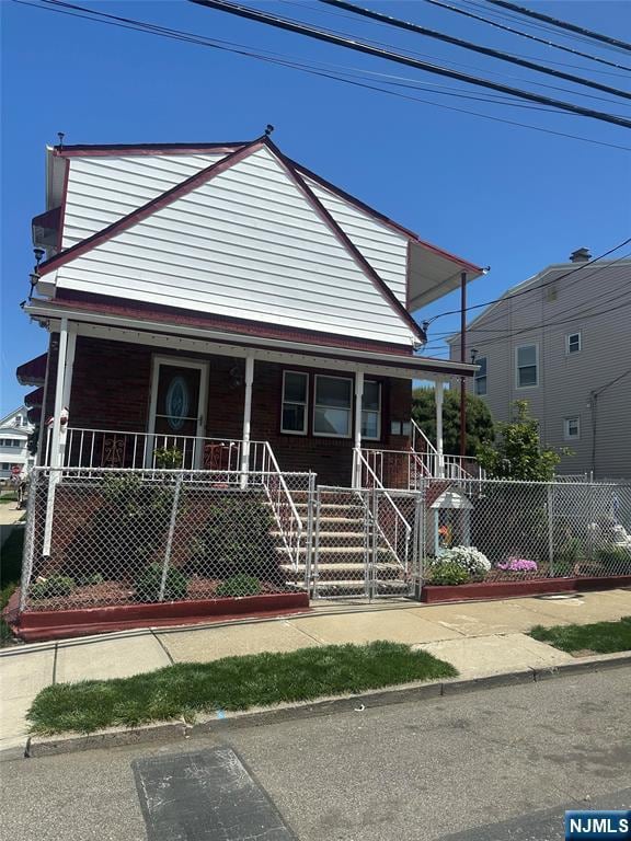280-282 Jefferson St, Paterson, NJ 07522 - view of front of property featuring covered porch, a fenced front yard, and a gate