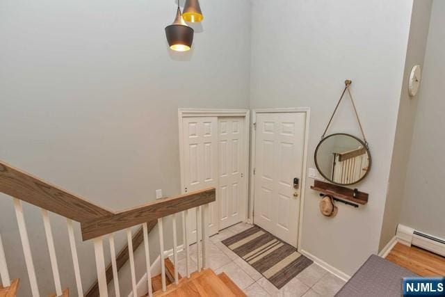 entryway with light tile patterned floors and baseboards