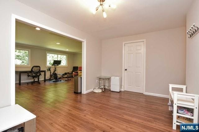 interior space featuring baseboards and wood finished floors