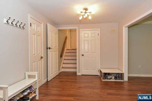 mudroom featuring baseboards, wood finished floors, and a chandelier