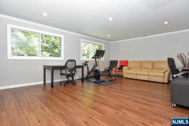 interior space featuring baseboards, ornamental molding, and light wood finished floors