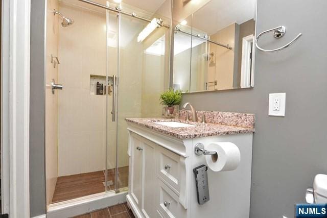 full bath featuring vanity and a stall shower