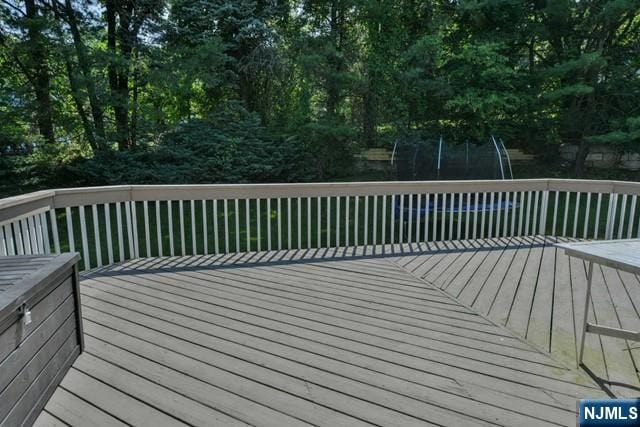 wooden deck with a trampoline