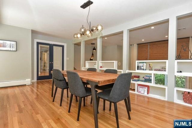 dining room with french doors, a baseboard radiator, light wood finished floors, a chandelier, and recessed lighting