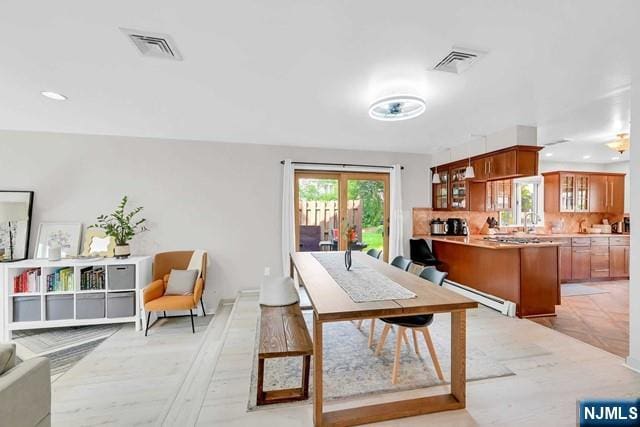dining room with visible vents, a baseboard radiator, and recessed lighting