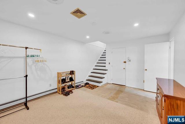 interior space with visible vents, recessed lighting, and carpet floors