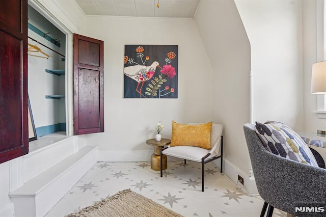 sitting room with tile patterned floors and baseboards