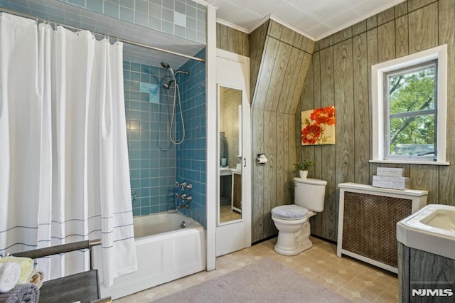 full bathroom featuring vanity, radiator, shower / bath combo, and toilet