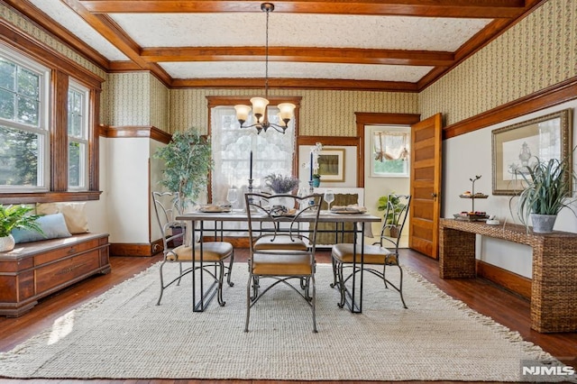 dining space featuring plenty of natural light, wallpapered walls, and wood finished floors