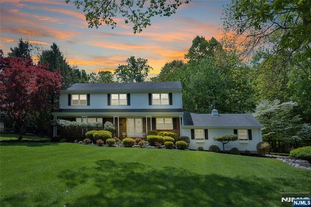 traditional-style house with a front lawn