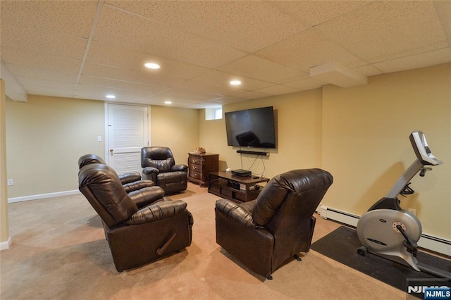 living area with carpet, a baseboard heating unit, a drop ceiling, recessed lighting, and baseboards