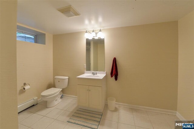 bathroom with baseboard heating, tile patterned flooring, toilet, and vanity