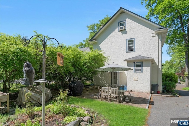 back of property featuring stucco siding and a patio area