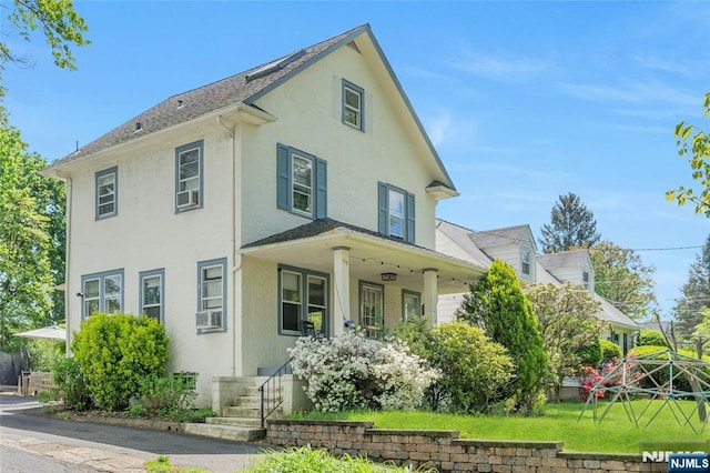 view of front facade featuring covered porch and stucco siding
