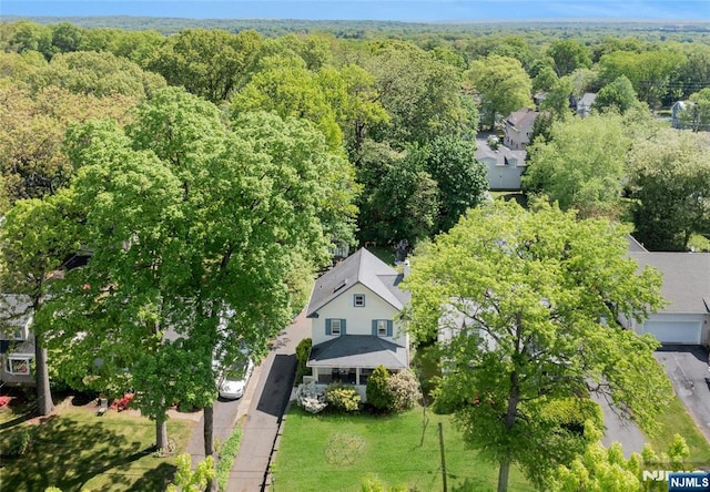 view from above of property featuring a heavily wooded area